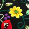 Refajo bordado a mano negro con preciosas ramas de flores en distintos tonos con lanas matizadas de diferentes colores en cada flor.