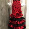 Falda de flamenca roja con lunar negro de tejido streck muy movida para tus bailes