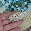 Broche metal con piedras brillantes